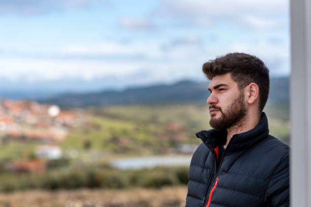 istock serious young bearded man looking away 1379974686