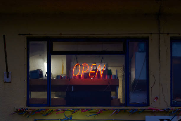istock A neon red open sign in a dark shop window 1379977386