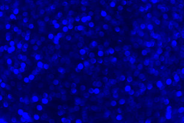 Bright blue texture with sparkles that are out of focus.