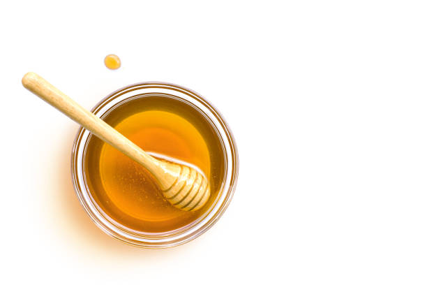 istock honey in glass bowl isolated on white 1379987613