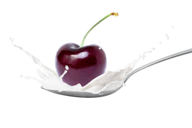 istock Milk or yogurt splash with fresh red berry cherry fruit isolated on white 1379987688