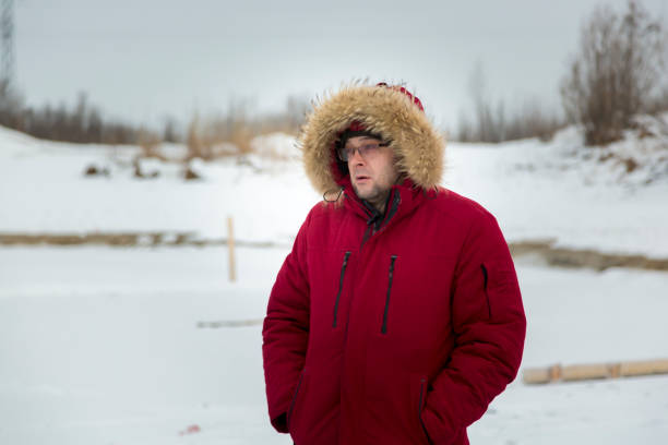 istock Portrait of a worker in a red jacket at a construction site 1380009366