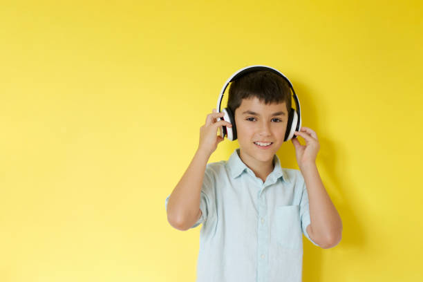 istock Happy smiling boy wearing wireless headphones 1380011599