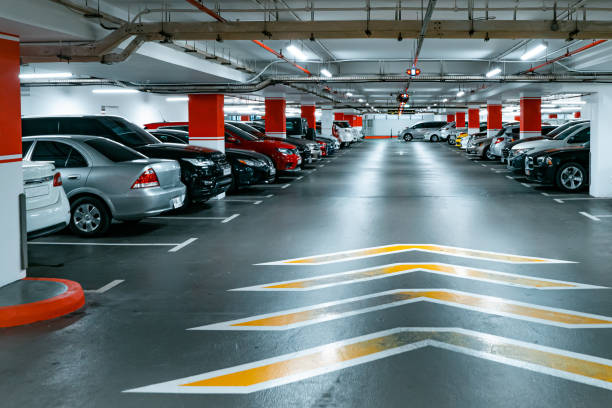 istock Parking garage underground interior background or texture. Concrete grunge wall and column with warning sign, industrial retro vintage interior 1380017763