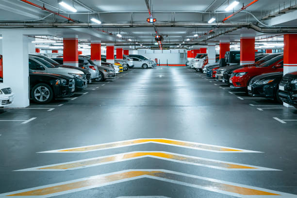 istock Parking garage underground interior background or texture. Concrete grunge wall and column with warning sign, industrial retro vintage interior 1380017767