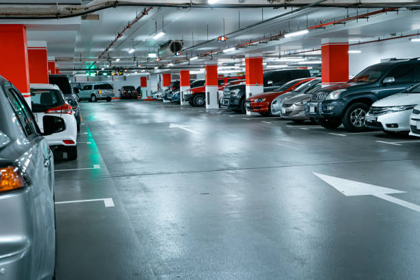 istock Parking garage underground interior background or texture. Concrete grunge wall and column with warning sign, industrial retro vintage interior 1380018054