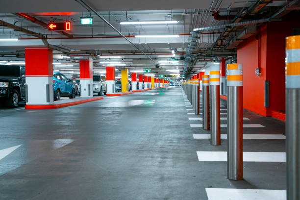 istock People at the zebra crossing underground Parking. Parking garage underground interior, pedestrian crossing, neon lights in dark industrial building 1380018284