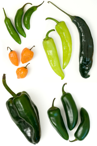Selection of Fresh Mexican Chili peppers. Clockwise from top left corner: serrano, Cubanelle, Chilaca, jalapeno, poblano and habanero.