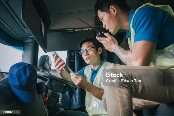 Asian Chinese Semi Truck Driver Communicate With Factory Warehouse Worker On Delivery Loading List Stock Photo - Download Image Now