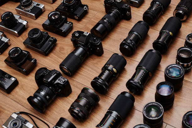 Top view of large group of analog vintage 35mm film cameras lying in arrangement close to each other Top view of large group of analog vintage 35mm film cameras lying in arrangement close to each other 35mm movie camera stock pictures, royalty-free photos & images