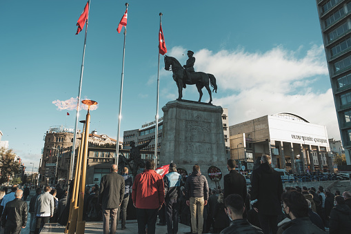 Ankara, Turkey - November 10, 2021: Victory Monument Ankara and people standing in homage on 10 November because the day is Ataturk's death anniversary.