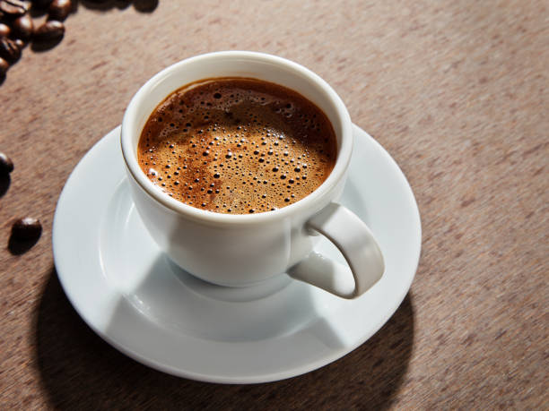 istock Coffee cup and beans on a dark background. 1380057869