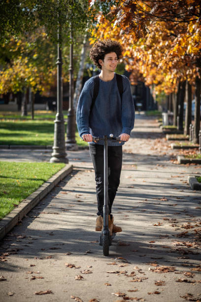 istock Student rides an electric scooter around the square 1380059460