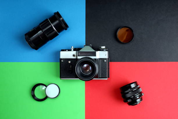istock The old film camera and lenses lie on different four backgrounds 1380064003