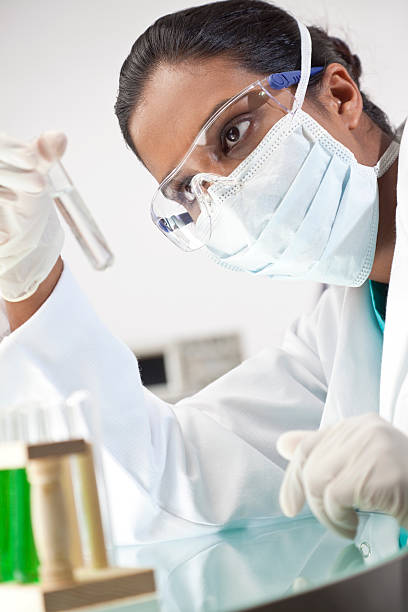 istock Female Asian Laboratory Scientist With Test Tube of Clear Solution 138006643