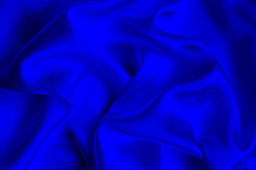 Crumpled satin fabric. Beautiful and flowing drapery lines.