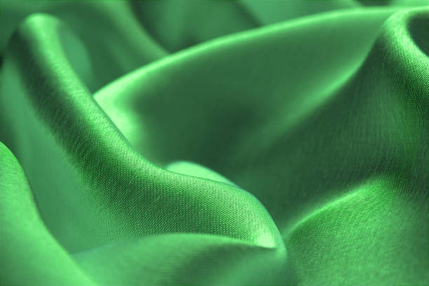 istock Green satin fabric. Beautiful and smooth lines of drapery. 1380069103