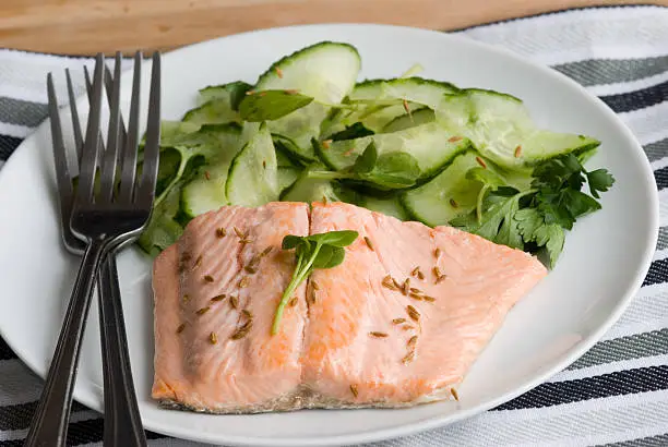 Poached seatrout with salad on a plate