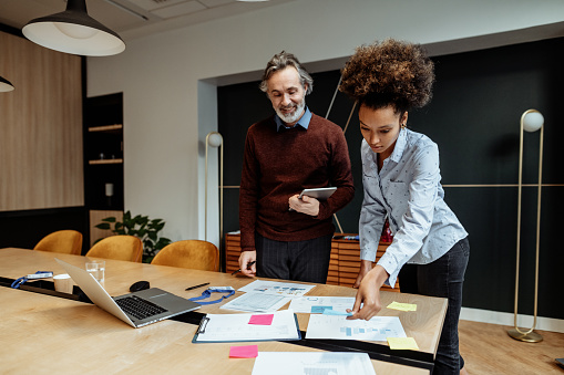 Business people dressed in smart casual clothing working in office. Models are fresh faces on stock photos and videos