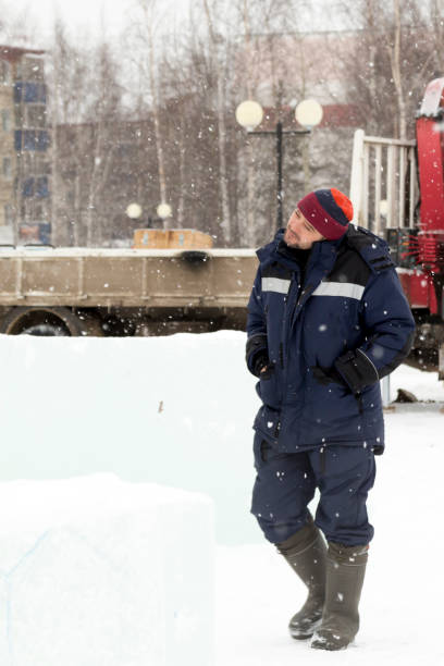 istock A worker in a blue winter suit walks through a construction site 1380086496