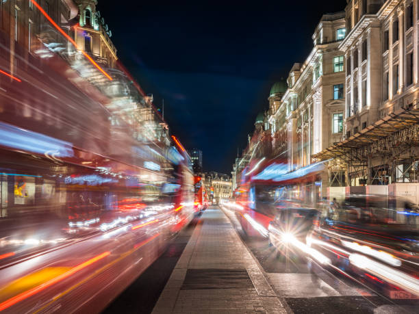 istock London red double decker buses zooming down Regent Street night 1380089071
