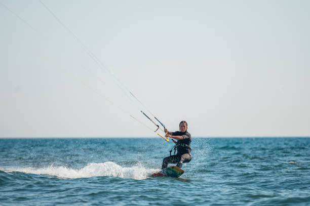 istock Woman kitesurfing on the ocean waters 1380089137