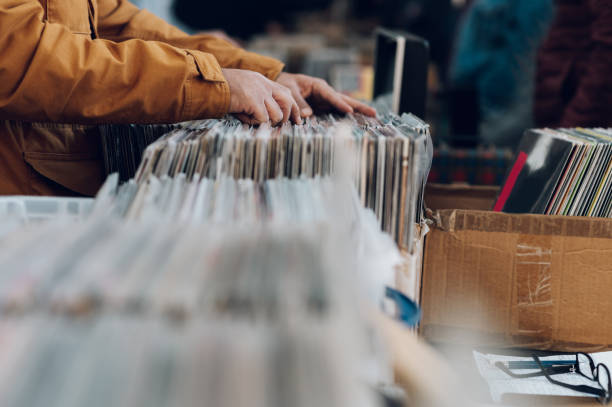 istock Man hands browsing vinyl album in a record store 1380089148