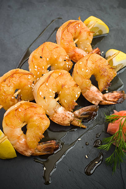 Fried jumbo shrimps Fried jumbo shrimps on skews, ready to eat black tiger shrimp stock pictures, royalty-free photos & images