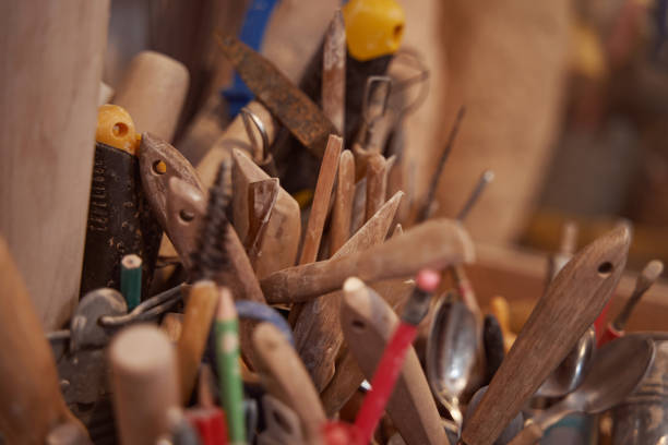 Assorted graphite pencils and pottery instruments with wooden handles used by ceramic artists