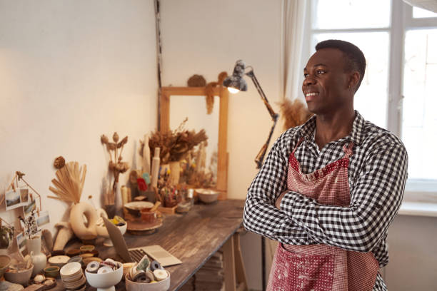 istock Dreamy potter standing in his pottery studio 1380115958