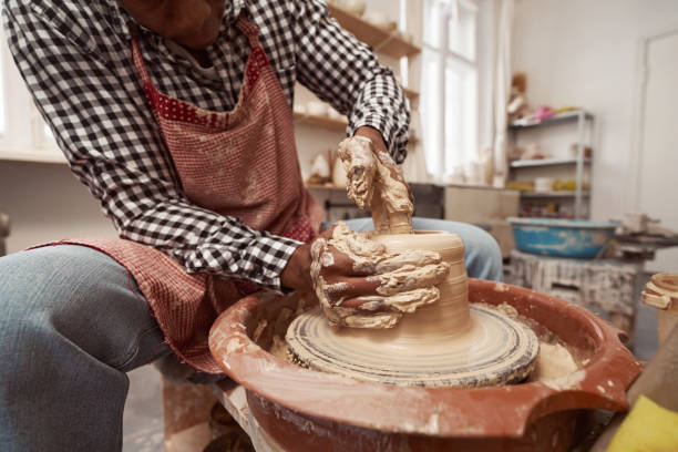 istock Experienced craft artist working on pottery wheel 1380115988