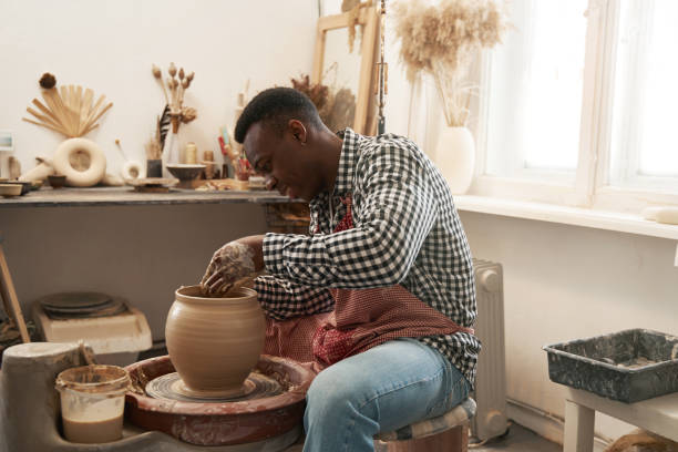 istock Cheerful man working on new clay vessel 1380115996