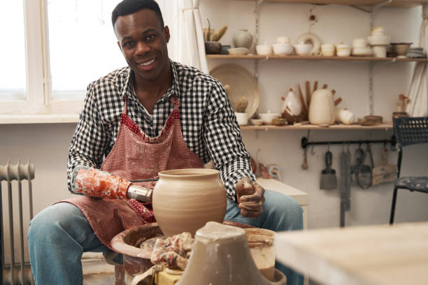 istock Smiling happy ceramist posing for camera in workplace 1380116000