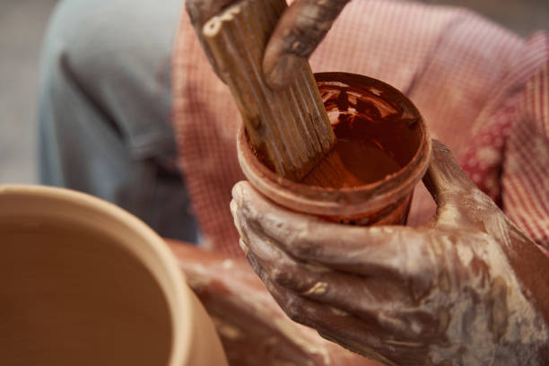 istock Craft artist mixing ceramic glaze in his studio 1380116002