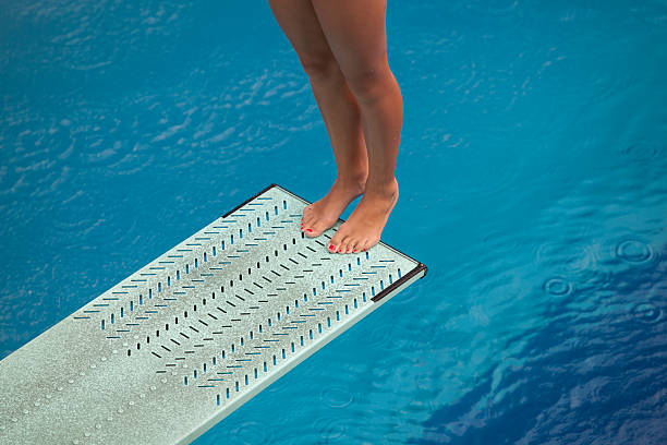 istock Female legs on diving board of pool 138011618
