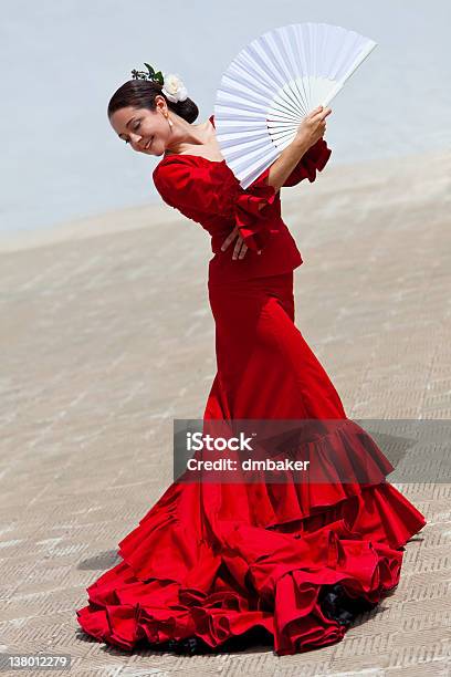 Traditional Woman Spanish Flamenco Dancer In Red Dress With Fan Stock Photo - Download Image Now