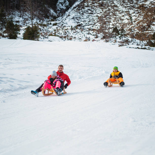 istock Family sledding on the snow 1380127167