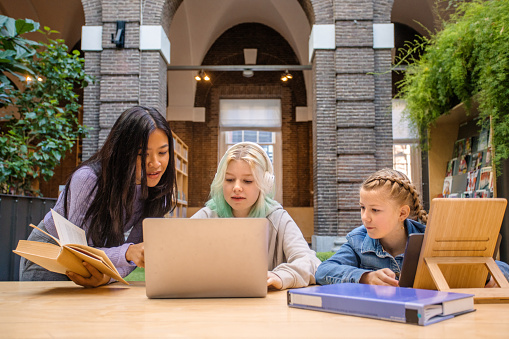 Beautiful family studying together in a public library