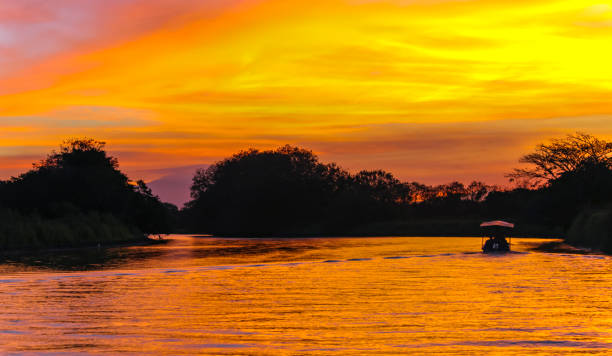 istock Heavenly cloudy landscape with bright sunset over the river. 1380159505