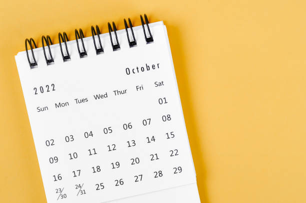 istock October 2022 desk calendar on light yellow background. 1380187268