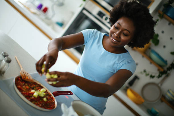 istock Young woman is cooking lunch in the kitchen. 1380197436