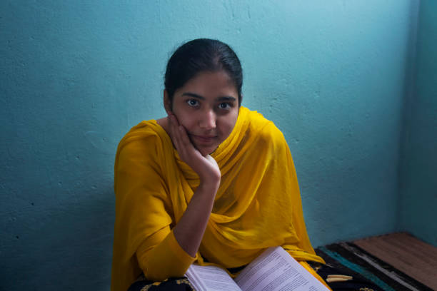 istock A girl in school uniform thinking while studying at home 1380221712