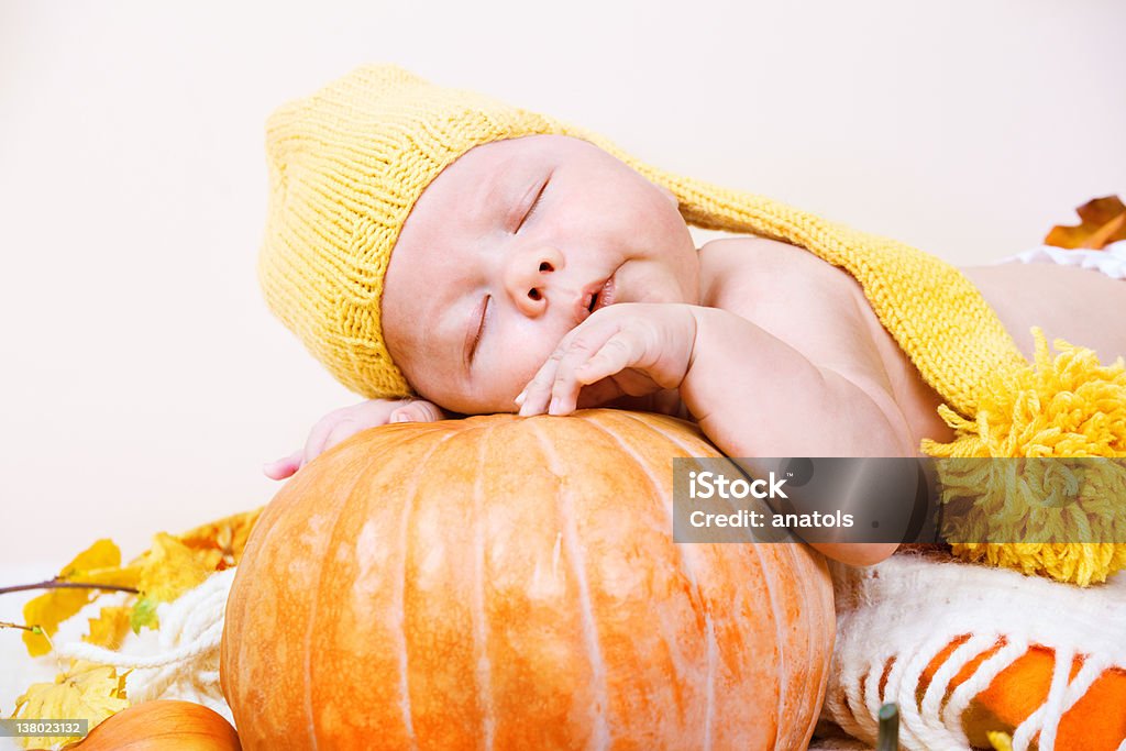 Halloween baby Portrait of an innocent Halloween baby in yellow hat Autumn Stock Photo