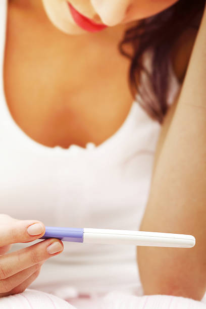 istock Sad woman holding pregnancy test 138023190