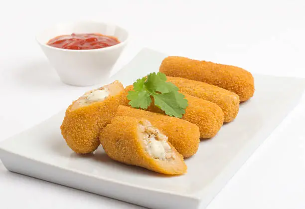 Chicken and cheese croquettes served with chili sauce.