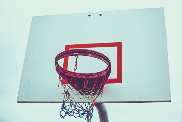 istock Low angle of basketball hoop with red white blue net 1380255368