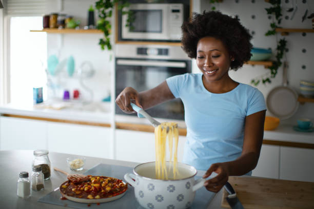 istock Young woman is cooking lunch in the kitchen. 1380258001