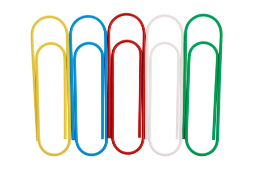 Large colorful paperclips in a row isolated on white