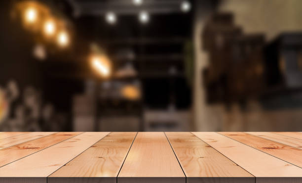 istock Empty wooden table top with lights bokeh on blur restaurant background. 1380262265
