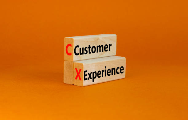 istock CX customer experience symbol. Concept words CX customer experience on wooden blocks on beautiful orange table orange background, copy space. Business and CX customer experience concept. 1380280303
